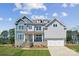 Two-story home featuring stone accents, multi-pane windows, and a two-car garage at 117 Jentri Way, Mooresville, NC 28115