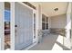 Covered porch and a gray front door with sidelight and decorative stone base at 117 Jentri Way, Mooresville, NC 28115