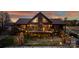 Log cabin with deck, string lights, and beautiful sunset at 120 Rockin J Rd, Maiden, NC 28650