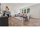 Spacious living room with stone fireplace, hardwood floors, and ample natural light at 121 Jentri Way, Mooresville, NC 28115