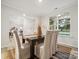 Dining area with dark wood table, neutral chairs, and a view of the backyard at 205 E Warfield Dr, Mooresville, NC 28115