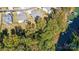 Aerial view of home showcasing a large lot, fenced backyard, mature trees, and proximity to the water at 4116 Spring Cove Way, Belmont, NC 28012