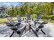 Outdoor stone fire pit with Adirondack chairs offers a cozy and inviting space for relaxation and entertainment at 4116 Spring Cove Way, Belmont, NC 28012