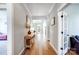 Long hallway featuring hardwood floors, neutral walls, and views of the home's interior layout at 4116 Spring Cove Way, Belmont, NC 28012