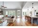 Open-concept living space with hardwood floors, neutral walls, and a seamless transition to the kitchen and dining area at 4116 Spring Cove Way, Belmont, NC 28012