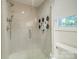 Large walk-in shower with glass enclosure and modern tile at 3728 Craig Ave, Charlotte, NC 28211