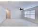 This bonus room has carpet floors, a ceiling fan, and a window with blinds at 6416 Red Maple Dr, Charlotte, NC 28277