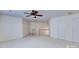 This bonus room has carpet floors, a ceiling fan, and a staircase at 6416 Red Maple Dr, Charlotte, NC 28277