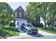 Charming two-story brick home with a well-manicured lawn, driveway, and modern grey SUV parked in front at 6416 Red Maple Dr, Charlotte, NC 28277