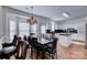 Well-lit kitchen and eat-in area with a large table, pendant lighting, and abundant natural light from large windows at 6416 Red Maple Dr, Charlotte, NC 28277