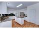 Bright kitchen with white cabinets, granite countertops, stainless steel appliances, and a central island at 6416 Red Maple Dr, Charlotte, NC 28277
