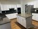 This kitchen has white cabinets, granite countertops, stainless steel appliances, and an island at 6416 Red Maple Dr, Charlotte, NC 28277