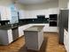 This kitchen features white cabinets, granite countertops, stainless steel appliances, and an island at 6416 Red Maple Dr, Charlotte, NC 28277