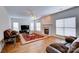 Spacious living room with hardwood floors, fireplace, ceiling fan, and large windows for natural light at 6416 Red Maple Dr, Charlotte, NC 28277