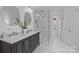Modern bathroom featuring a dual-sink vanity, a glass-enclosed shower, and stylish fixtures at 5303 Shasta Hill Ct, Charlotte, NC 28211
