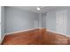 Neutral bedroom with hardwood flooring, white trim, and a ceiling fan at 5303 Shasta Hill Ct, Charlotte, NC 28211