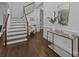 Elegant foyer with wood floors, staircase, and a chic console table at 5303 Shasta Hill Ct, Charlotte, NC 28211