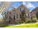 Charming brick home with black shutters, manicured landscaping and a welcoming front entrance at 5303 Shasta Hill Ct, Charlotte, NC 28211