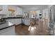 Bright kitchen featuring white cabinetry, dark countertops, and stainless steel appliances at 5303 Shasta Hill Ct, Charlotte, NC 28211