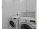 Convenient laundry room featuring a washer, dryer, and storage cabinets at 5303 Shasta Hill Ct, Charlotte, NC 28211