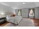Spacious main bedroom featuring a tray ceiling, large windows, and a decorative accent wall at 5303 Shasta Hill Ct, Charlotte, NC 28211
