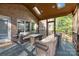 Relaxing screened porch with comfortable seating, skylights, and a view of the outdoor landscape at 5303 Shasta Hill Ct, Charlotte, NC 28211