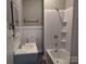 Bathroom with white tub and shower, grey walls and floor, and white vanity at 602 W Council St, Salisbury, NC 28144