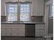 Charming kitchen featuring white cabinets, granite countertops and stainless dishwasher at 602 W Council St, Salisbury, NC 28144