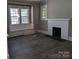 Inviting living room featuring new flooring, fireplace, and abundant natural light at 602 W Council St, Salisbury, NC 28144