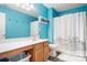 Small bathroom with light blue walls, a shower, and a vanity at 112 Sugar Thyme Ln, Mooresville, NC 28115