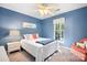 Blue bedroom with a ceiling fan, a bed with white bedding, and a chair at 112 Sugar Thyme Ln, Mooresville, NC 28115