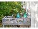 Spacious deck with gray railings, teal chairs, and potted plants at 112 Sugar Thyme Ln, Mooresville, NC 28115