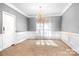 Elegant dining room featuring chandelier and wainscoting at 112 Sugar Thyme Ln, Mooresville, NC 28115
