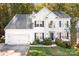 White two-story house with black shutters, landscaping, and a front porch at 112 Sugar Thyme Ln, Mooresville, NC 28115