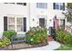 Inviting front entrance with brick steps, lush hydrangeas, and a black bench at 112 Sugar Thyme Ln, Mooresville, NC 28115