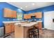 Kitchen boasts an island and blue painted walls at 112 Sugar Thyme Ln, Mooresville, NC 28115