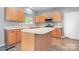 Kitchen features an island and stainless steel appliances at 112 Sugar Thyme Ln, Mooresville, NC 28115