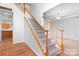 Elegant staircase with wooden railing and carpeted steps at 112 Sugar Thyme Ln, Mooresville, NC 28115