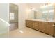 Bathroom with dual sinks and granite countertops and white cabinets at 1200 Meander Ln, Waxhaw, NC 28173