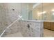 Modern bathroom shower features decorative stone tiling, shower head, and glass wall with bench at 1200 Meander Ln, Waxhaw, NC 28173