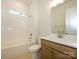 Bathroom features a tub and shower combination with tile surround and single sink vanity at 1200 Meander Ln, Waxhaw, NC 28173