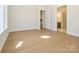 Bedroom with access to the kitchen and bathroom features hardwood floors at 1200 Meander Ln, Waxhaw, NC 28173