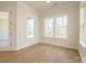 Bedroom with hardwood floors, recessed lights and large windows at 1200 Meander Ln, Waxhaw, NC 28173