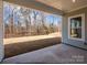 View from covered patio showing backyard with natural views and black aluminum fencing at 1200 Meander Ln, Waxhaw, NC 28173