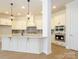 Elegant kitchen featuring white cabinetry, stainless steel appliances, and a large center island at 1200 Meander Ln, Waxhaw, NC 28173