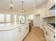 Bright, modern kitchen with white cabinets, an island with sink and pendant lighting at 1200 Meander Ln, Waxhaw, NC 28173