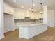 Modern kitchen with a large island, white cabinets, and stainless steel appliances at 1200 Meander Ln, Waxhaw, NC 28173