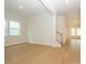 Open-concept living room with large windows providing natural light and hardwood flooring at 1200 Meander Ln, Waxhaw, NC 28173