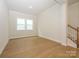 Spacious living room featuring hardwood floors and staircase at 1200 Meander Ln, Waxhaw, NC 28173