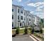 A row of modern townhouses with landscaping and community signage at 12110 Storm Ln # 49, Charlotte, NC 28277